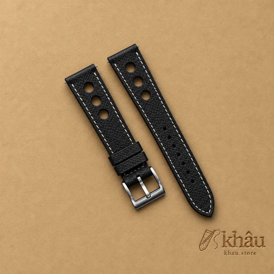 Black Epsom Rally Watch Strap with Ivory Stitching with Khâu debossed branding on a warm tan background