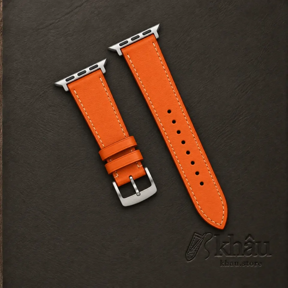Atelier Orange handmade orange cowhide band with ivory stitching and silver Apple Watch adapters