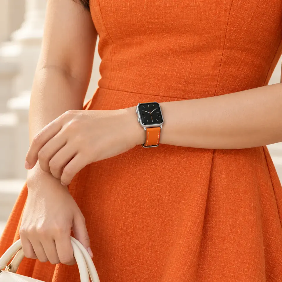 Atelier Orange worn on the wrist with a matching orange linen dress; watch not included